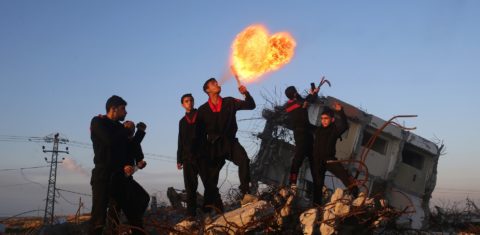 Jovens palestinos brincam com foto na Faixa de Gaza