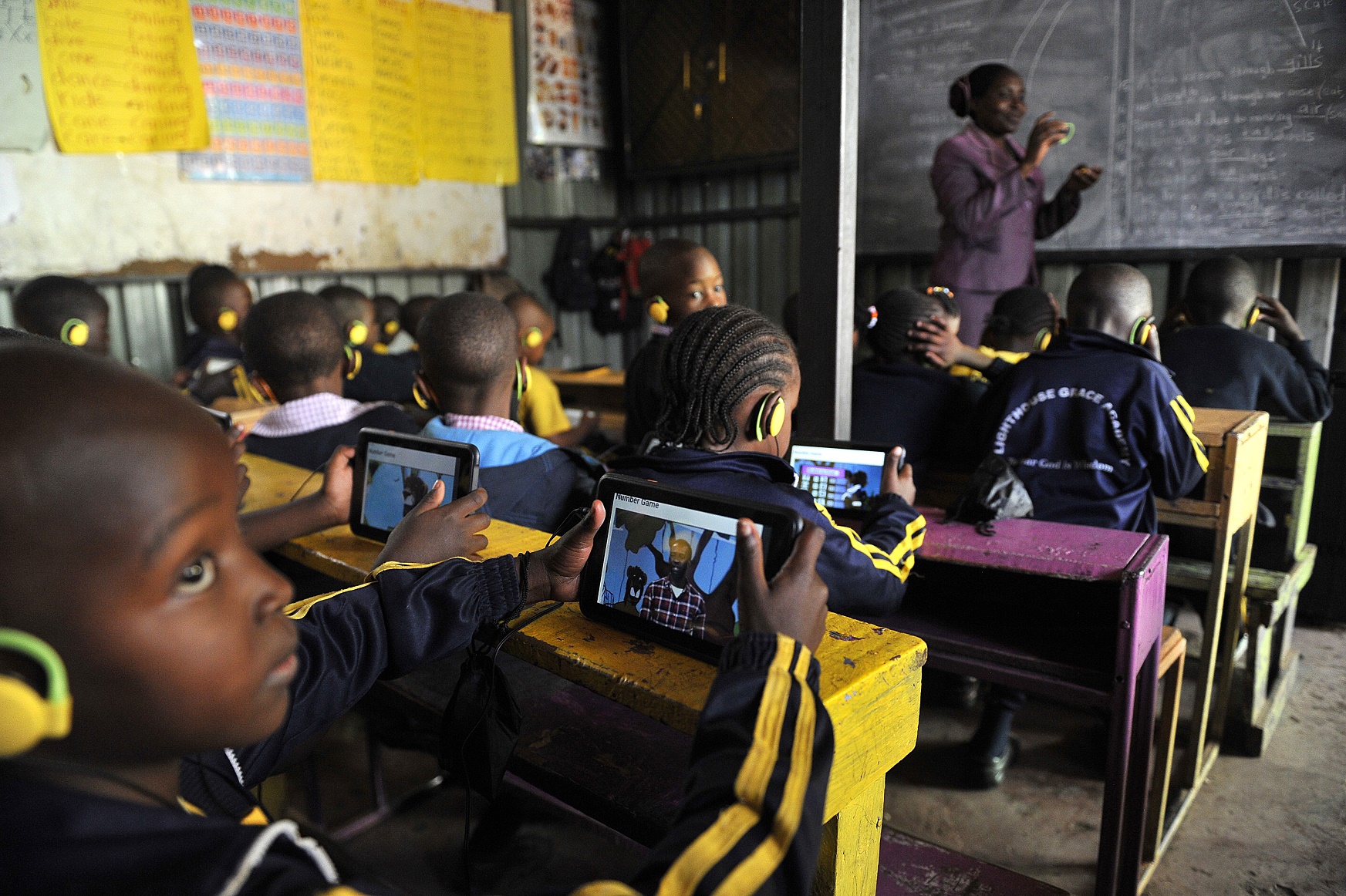 SIMON MAINA / AFP Crianças numa escola de Nairóbi, no Quênia, usam um modelo de tablet criado por uma empresa local