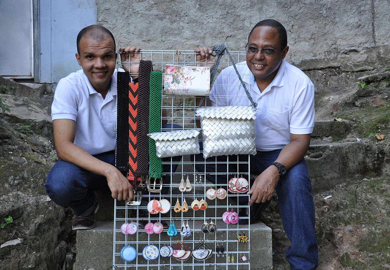 Divulgação Julio Cesar de Moraes, à direita, faz, com o filho Ricardo, bolsas, cintos, pulseiras, brincos e peças em macramê utilizando material reciclado. Divulgação