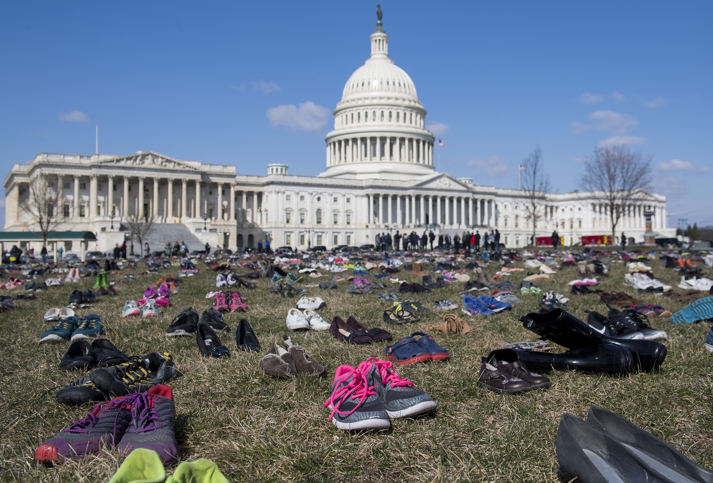Foto Saul Loeb/AFP Em um protesto em frente ao Capitólio, em Washington, sete mil pares de calçados lembram as crianças mortas por arma de fogo no país. Foto Saul Loeb/AFP