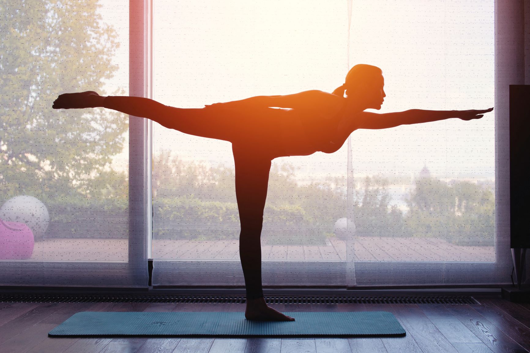 Mulher faz yoga ao pôr do sol: para pesquisadoras, indústria do bem-estar gerencia agenda diária das mulheres com "rotinas de cuidados com a pele, desafios de 30 dias, meditações, velas acesas, ioga e água com limão" (Foto: Sakkmesterke / AAT / Science Photo Library / AFP - 15/12/2021)