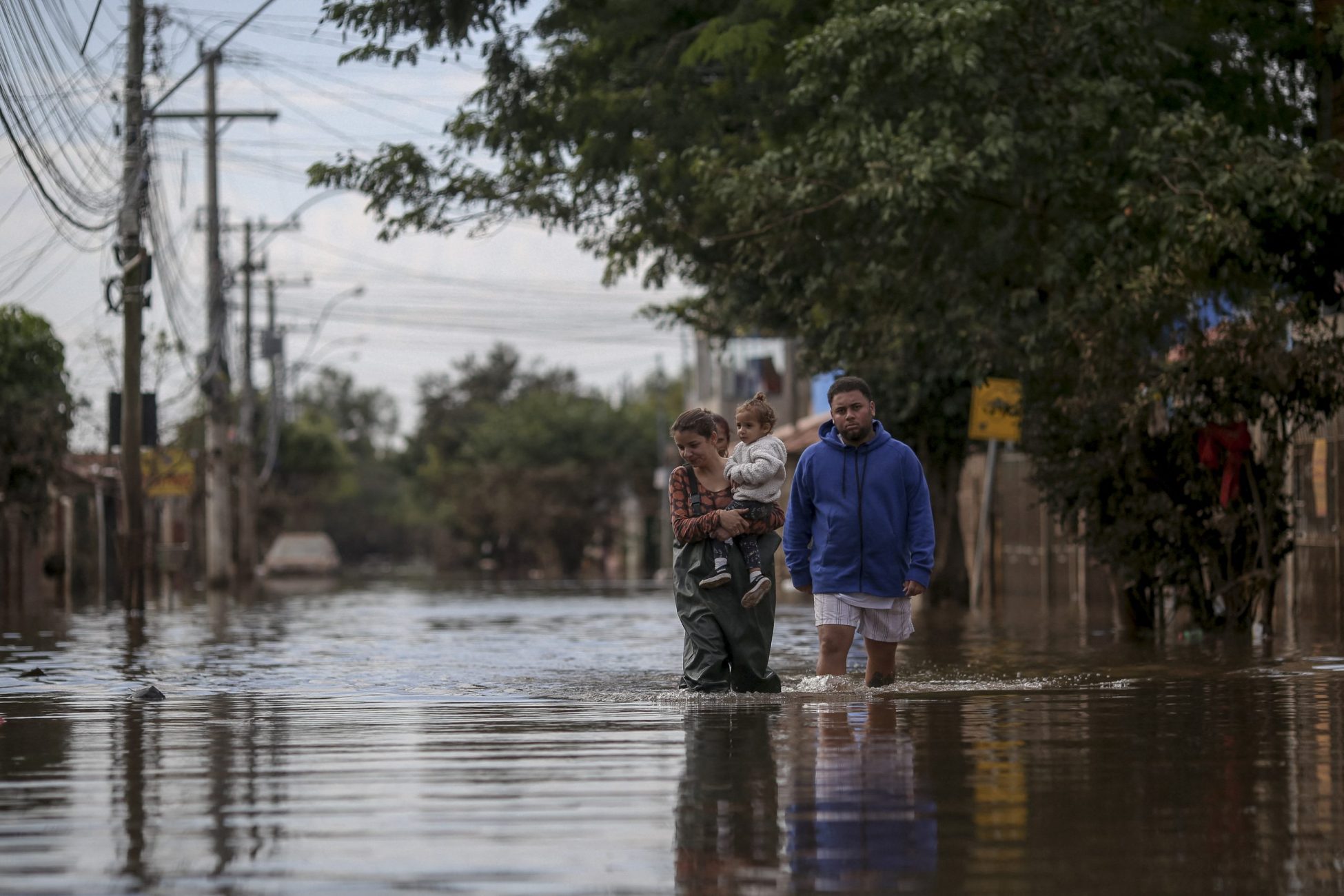Pessoas caminham por uma rua inundada no bairro Chácara, em Eldorado do Sul, no Rio Grande do Sul. Segundo levantamento do MapBiomas, entre 1985 e 2022, o estado perdeu 22% de sua vegetação nativa. Foto Anselmo Cunha/AFP