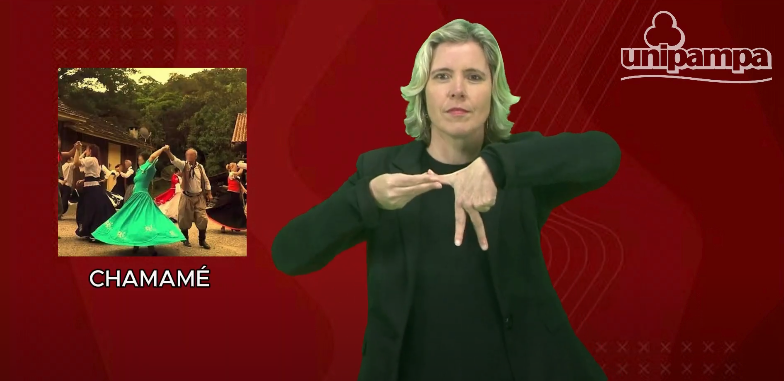 Captura de tela colorida do sinalário gaúcho de Libras. Na imagem, a professora Keli Krause aparece sinalizando a palavra chamamé. No lado esquerdo, aparece uma foto de pessoas dançando e o fundo é vermelho. Regionalismo em Libras
