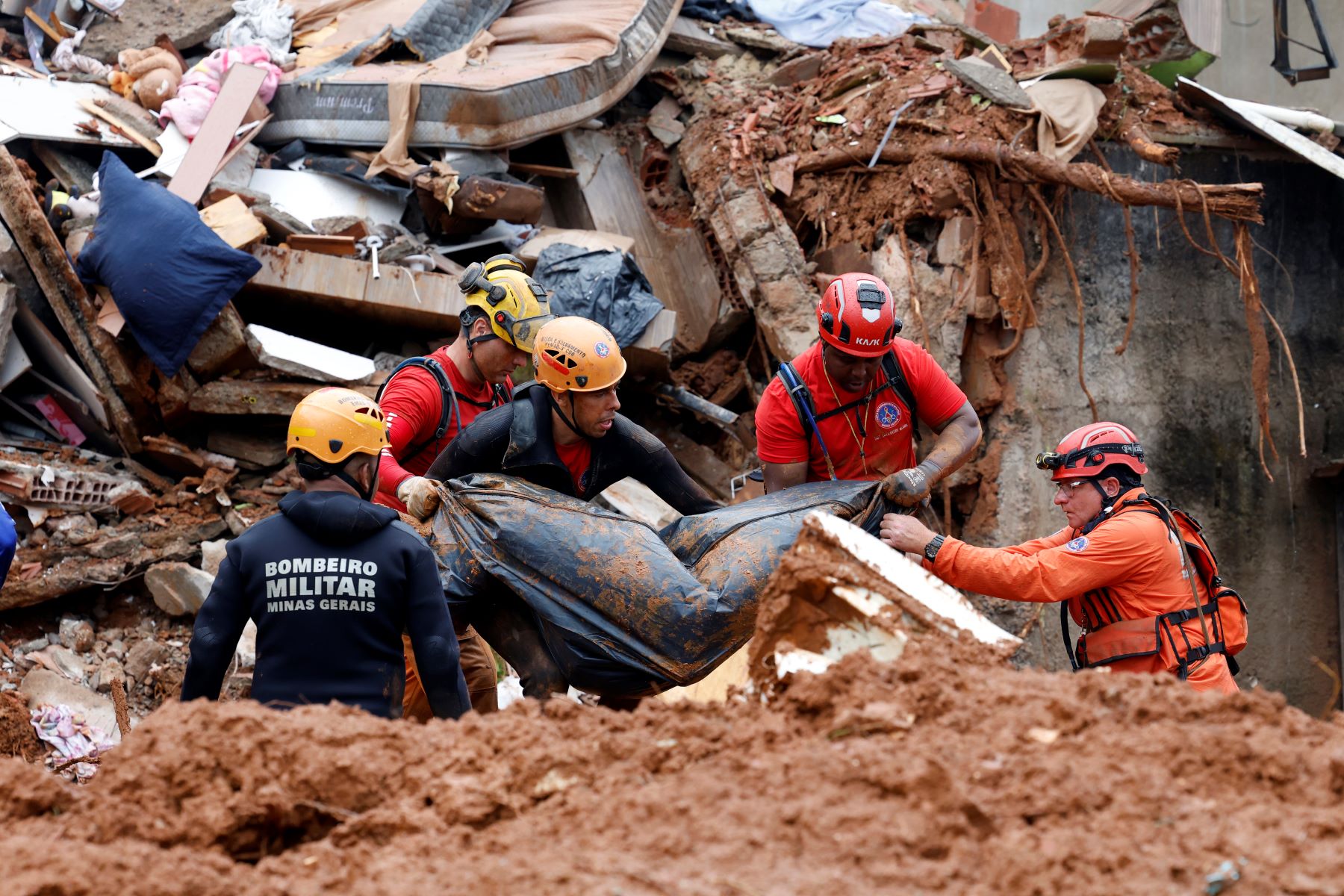 Soldados do Corpo de Bombeiros e voluntários fazem busca e resgate de pessoas em escombros de casas soterradas por lama após fortes chuvas em Juiz de Fora: mais de 30 mortos em Minas (Foto: Tânia Rêgo/Agência Brasil)